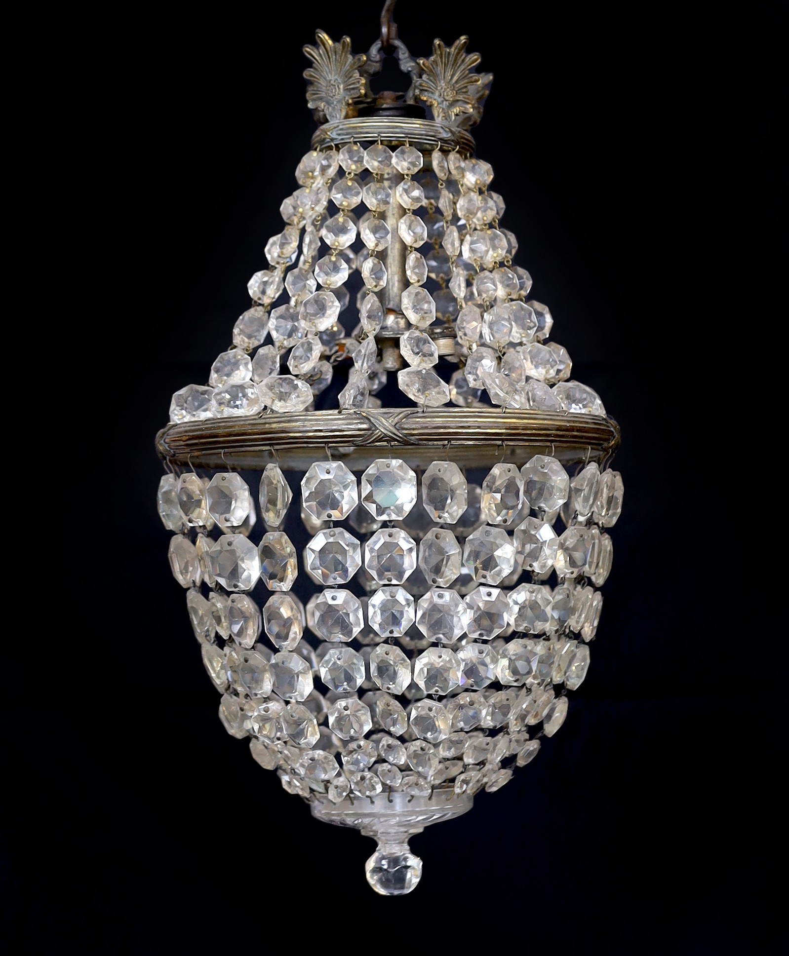 An early 20th century bronze and beaded crystal bag shaped chandelier with graduated octagonal cut drops, height 50cm. width 30 cm